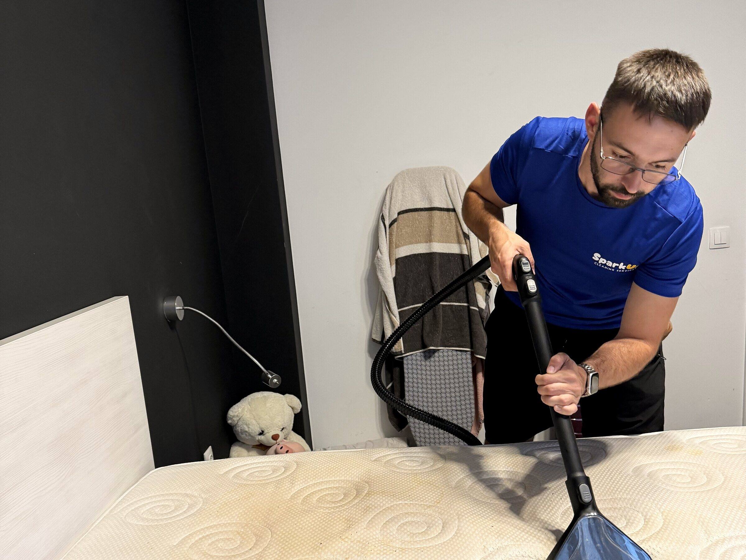SparkUp team member cleaning a mattress with a Kärcher extractor